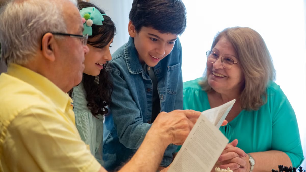 Happy family moments with grandparents and grandchildren enjoying time together indoors.